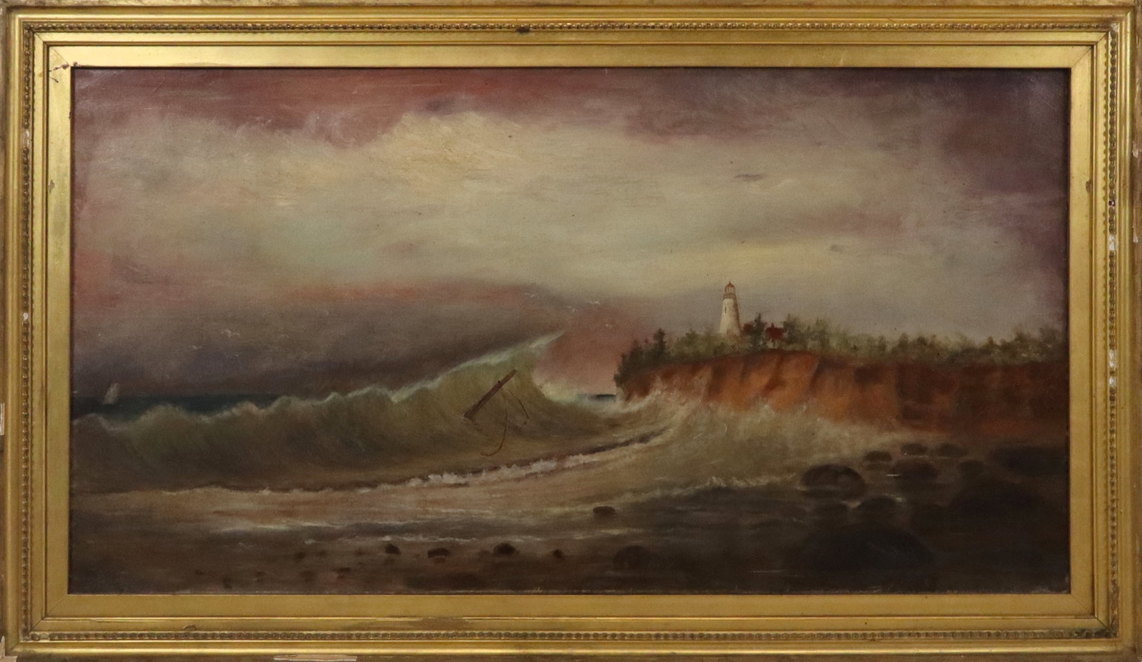 19th/20th Century Oil on Canvas Coastal Landscape: Late 19th-early 20th century oil on canvas, rocky coastal landscape with lighthouse, no apparent signature, gilt framed. [Canvas:18" H x 34" W; Frame: 22" H x 38" W]. Overall condition is good, wear c