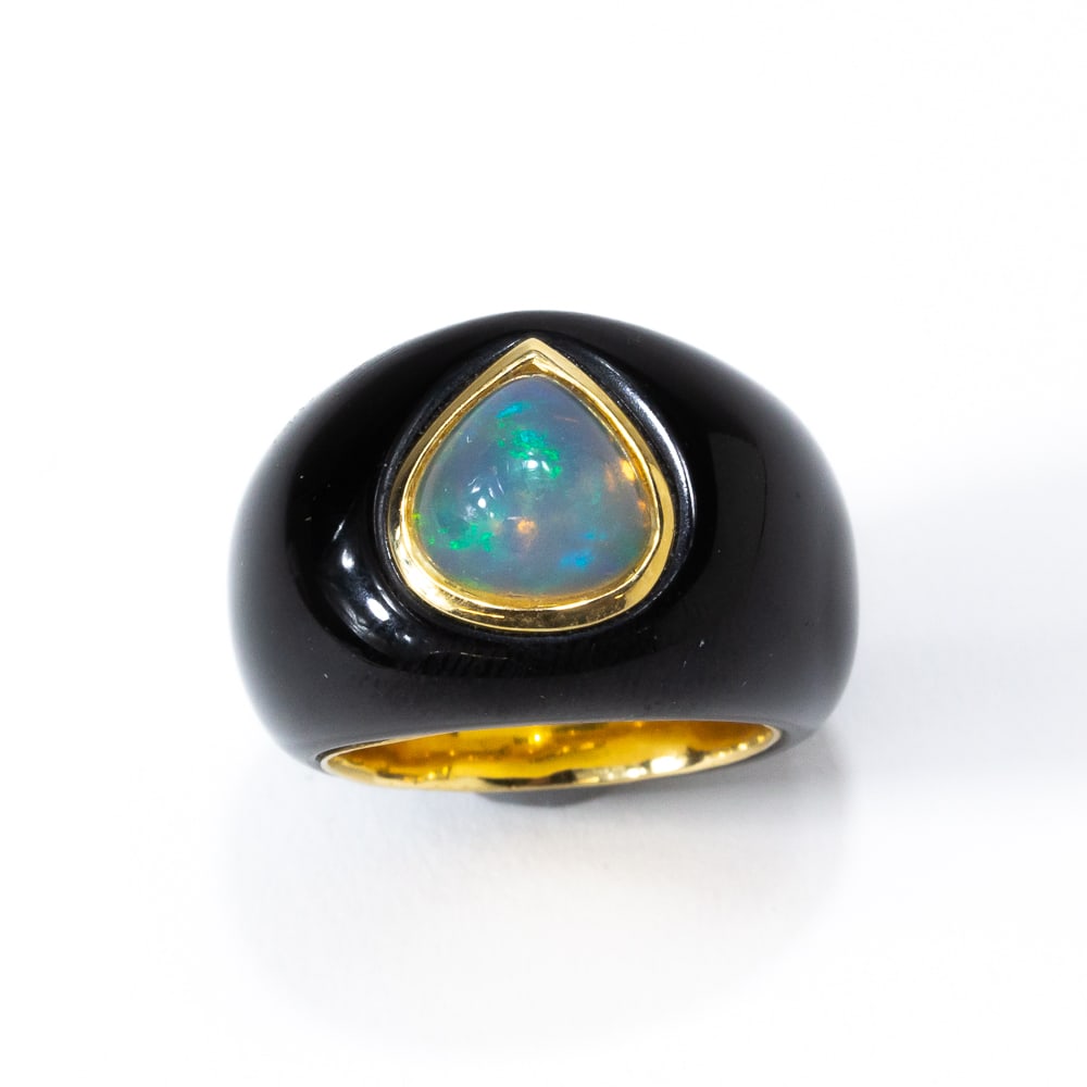 Black Jade, Opal & Gold Ring: Carved black jade, pear-shaped cabochon opal and gold ring, marked 18K. [10.38 dwt., Ring size: 6.5]. Overall condition is good. From the esteemed collection of Neil Zukerman former owner of CFM Galle