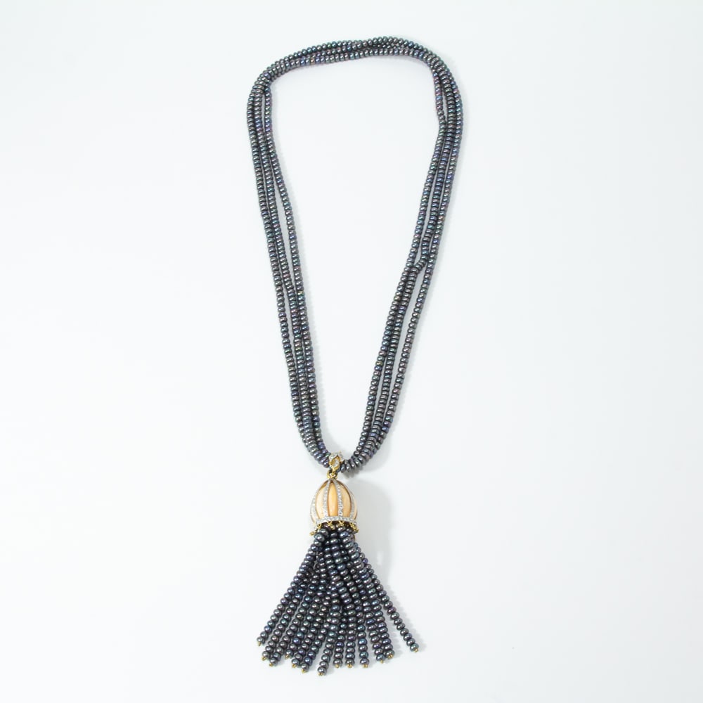 Black Pearl, Diamond & Coral Tassel Necklace: Black pearl, diamond, coral and gold tassel necklace, designed as three strands of black pearls, approximately 4.9 x 2.8mm, joined by a removable coral, diamond and black pearl 13 strand tassel pendan