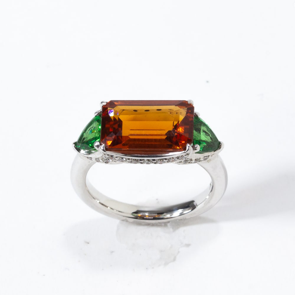 Mandarin and Tsavorite, Diamond and Gold Ring: Mandarin and tsavorite garnet, diamond and white gold ring, set horizontally and centered by an emerald-cut mandarin garnet, 12 x 7.75 x 4.4mm, accented with fancy-cut tsavorite garnet terminals, and 