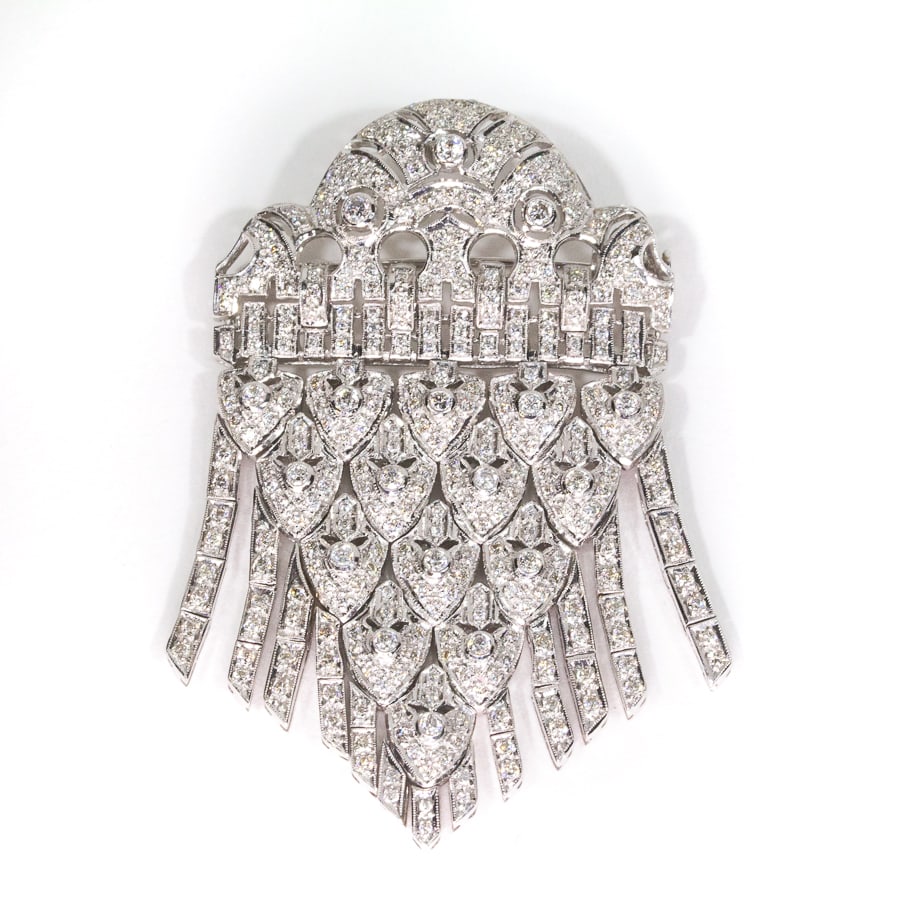 Diamond and Gold Fringe Pendant Brooch: Diamond and white gold flexible tassel pendant brooch, of shield shape the lower section articulated, set with approximately 315 round brilliant-cut diamonds, total approximately 3.45 cts., marked 18K