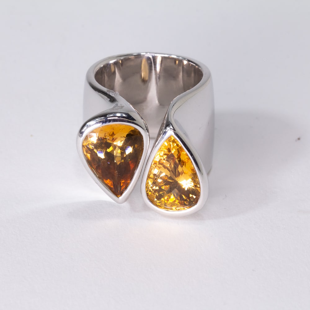Citrine & White Gold Bypass Ring: Pear-shaped citrine and white gold modern passerby ring, marked 18K. [21.55 dwt., Ring size: 6.25]. Overall condition is good. From the esteemed collection of Neil Zukerman former owner of CFM Gallery