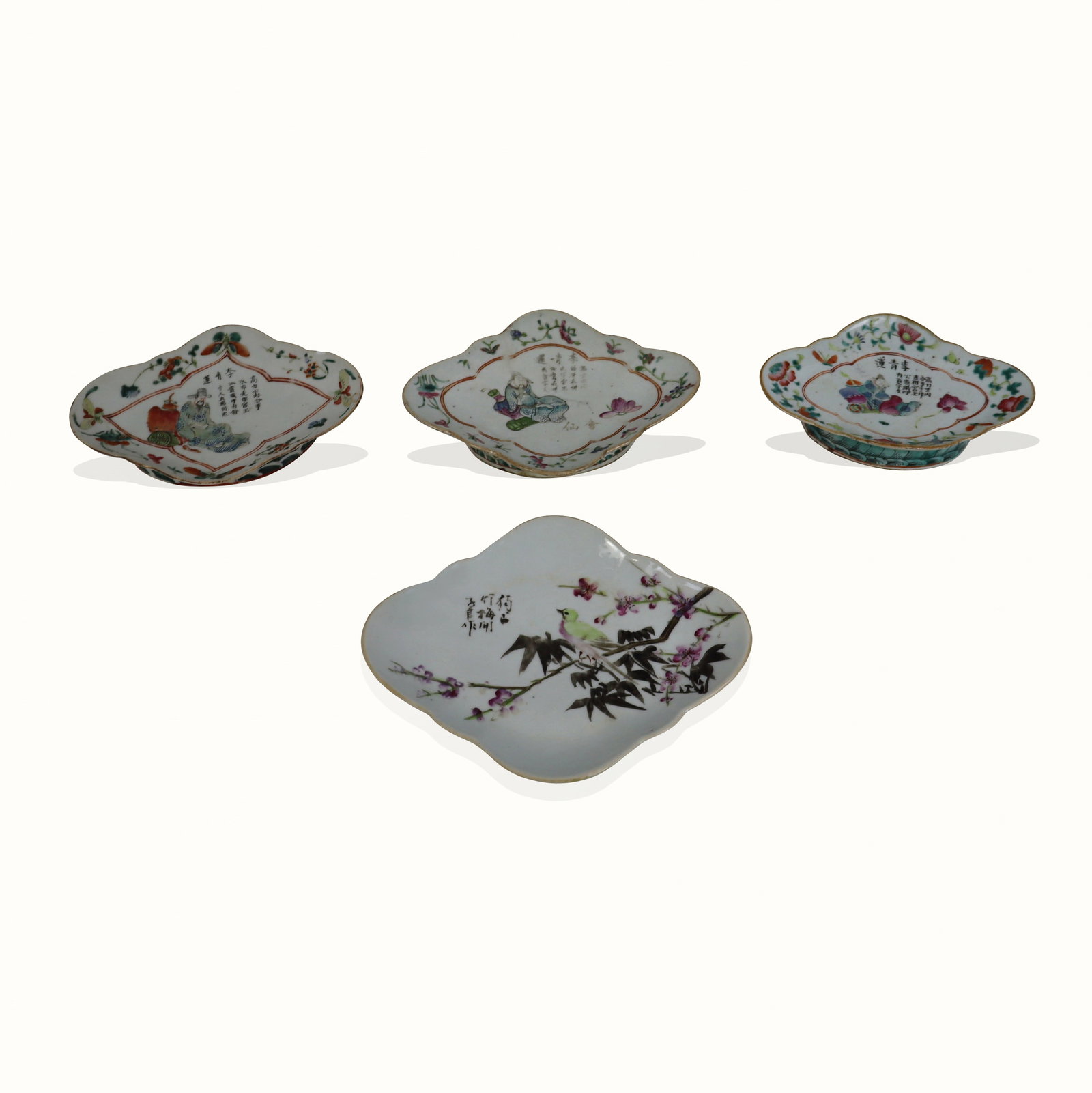 Four Chinese Famille Rose Footed Dishes: Four Chinese famille rose footed dishes, three late 19th century, one 20th century, three further accented with plum and bat motif, together with a larger cherry blossom decorated dish. [Largest: 10.2