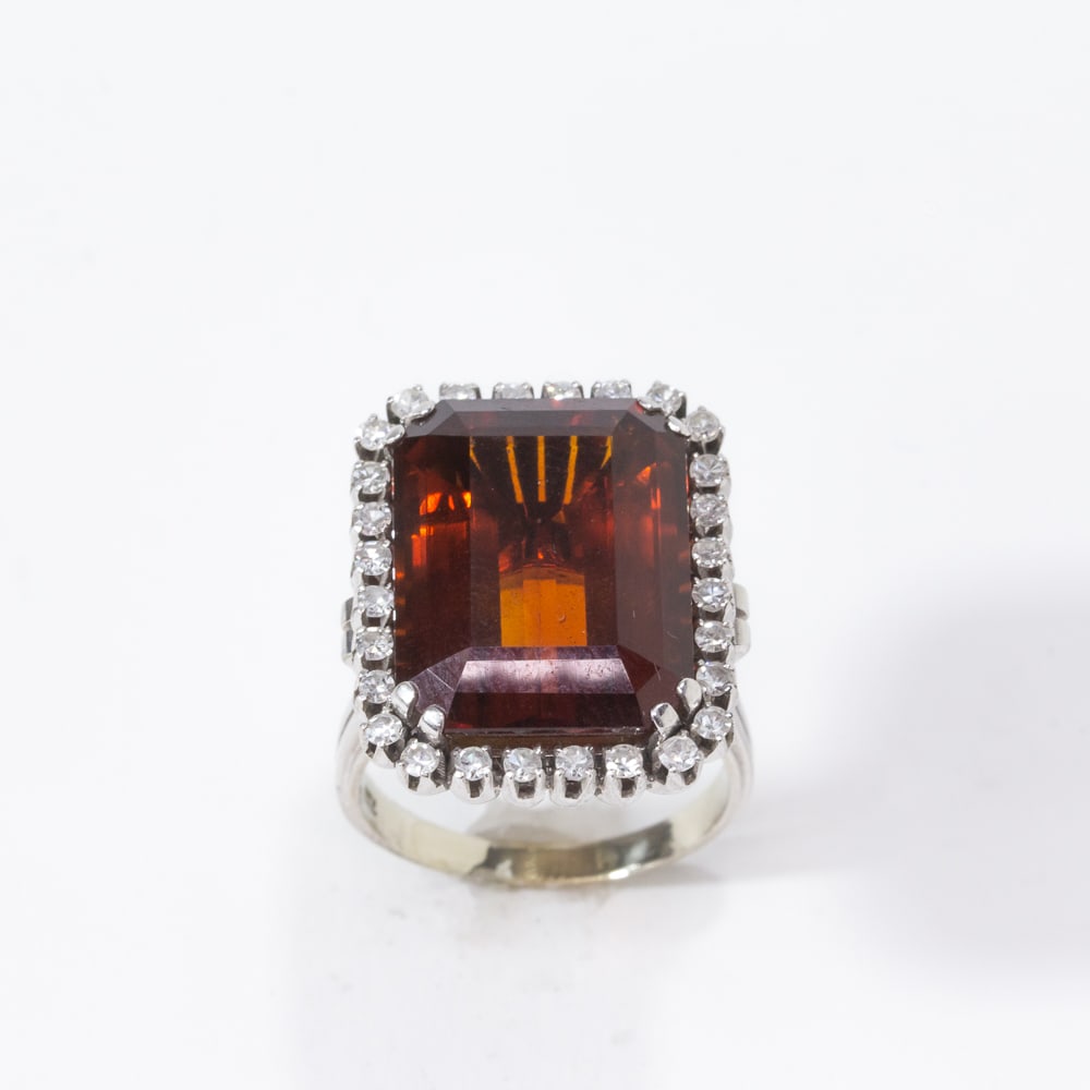 Citrine, Diamond & White Gold Ring: Madeira citrine; diamond and white gold ring, centered by an emerald-cut citrine, 19.1 x 14.5 x 9mm, framed by a border of 28 single-cut diamonds, total approximately .55 ct., interior shanked marked 