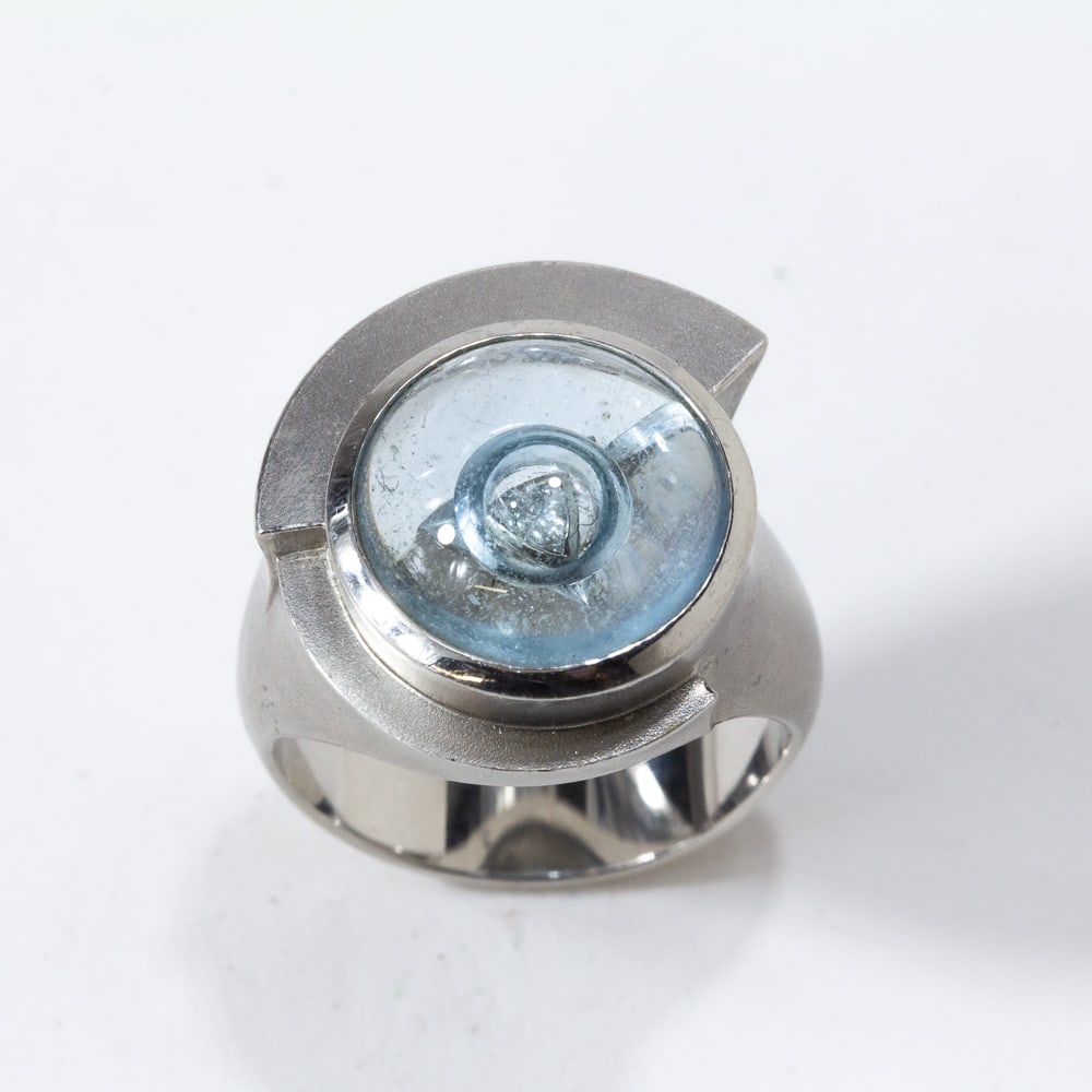 Tom Munsteiner Aquamarine, Diamond & Platinum Ring: Tom Munsteiner modernist cabochon aquarmine, brilliant-cut diamond and satin finished platinum ring, designed as a cabochon aquamarine resting above a fancy cut diamond, within a brushed platinum step