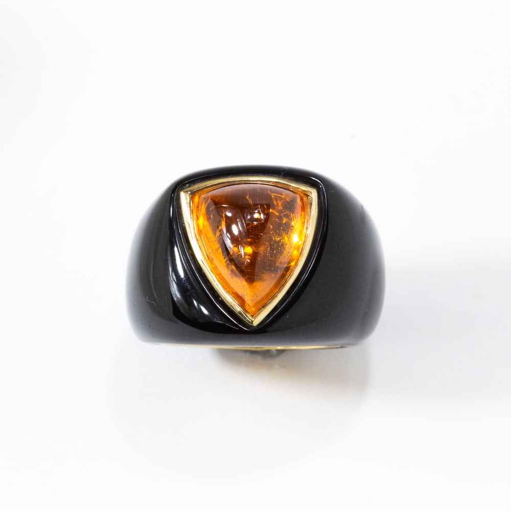 Black Jade, Fire Opal & Gold Ring: Carved black jade, triangular cabochon-cut fire opal and yellow gold ring, fire opal, approximately 11.21 cts, marked 14K on the interior gold band. [11.64 dwt., Ring size: 7]. Overall condition is go
