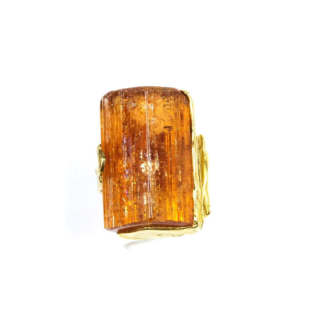 Wagner Topaz Crystal & Gold Ring: Wagner Topaz crystal and gold ring, Germany, circa 1970s, designed organically, the textured yellow gold mounting retaining a precious topaz crystal body, unmarked, tests for 18K. [19.05 dwt.; Ring si