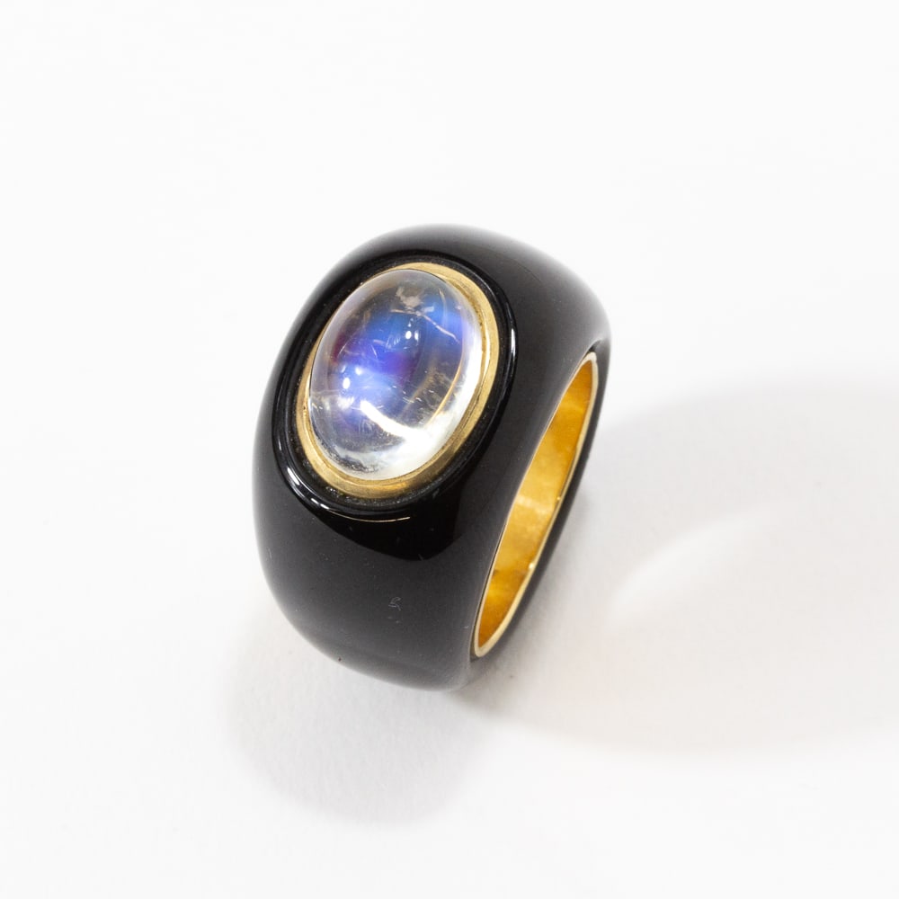 Black Jade, Moonstone & Gold Ring: Carved black jade, collet-set oval cabochon moonstone and yellow gold ring, interior shank marked 14K. [11.48 dwt., Ring size: 6.75]. Overall condition is gooOverall condition is good.From the esteeme