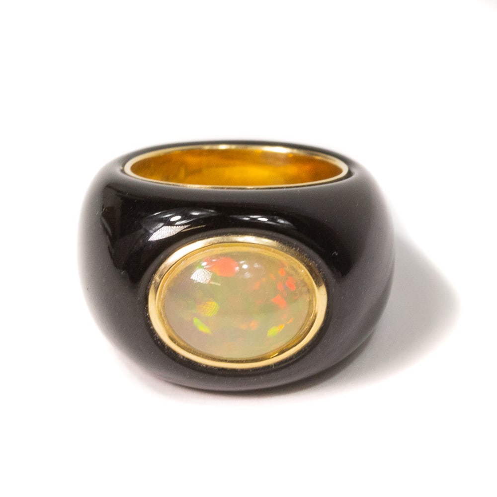 Black Jade, Opal & Gold Ring: Carved black jade, oval cabochon opal and gold ring, marked 14K. [11.09 dwt., Ring size: 6.75]. Overall condition is good.From the esteemed collection of Neil Zukerman former owner of CFM Gallery.