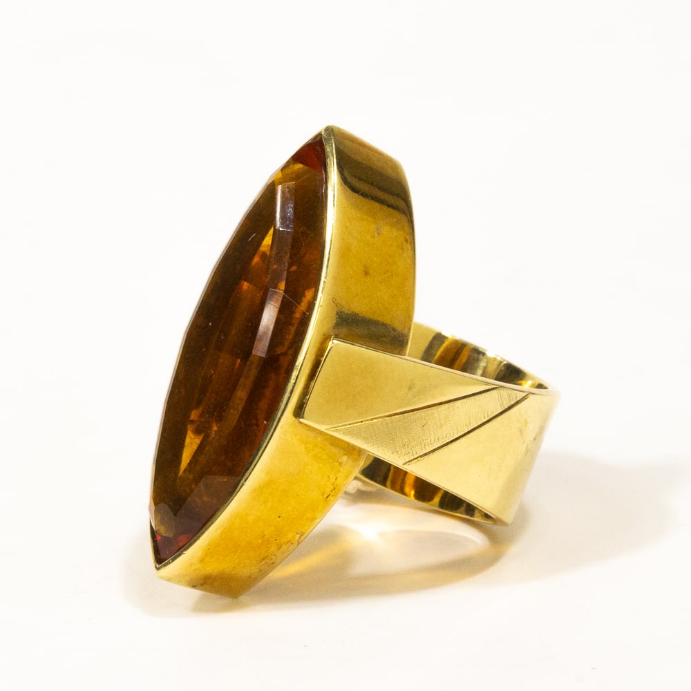 Citrine & Gold Ring: Marquise-cut citrine and yellow gold ring, the fancy-cut marquise shaped citrine,From the esteemed collection of Neil Zukerman former owner of CFM Gallery. 32 x 14.6 x 9mm, bezel-set in a wide gold as
