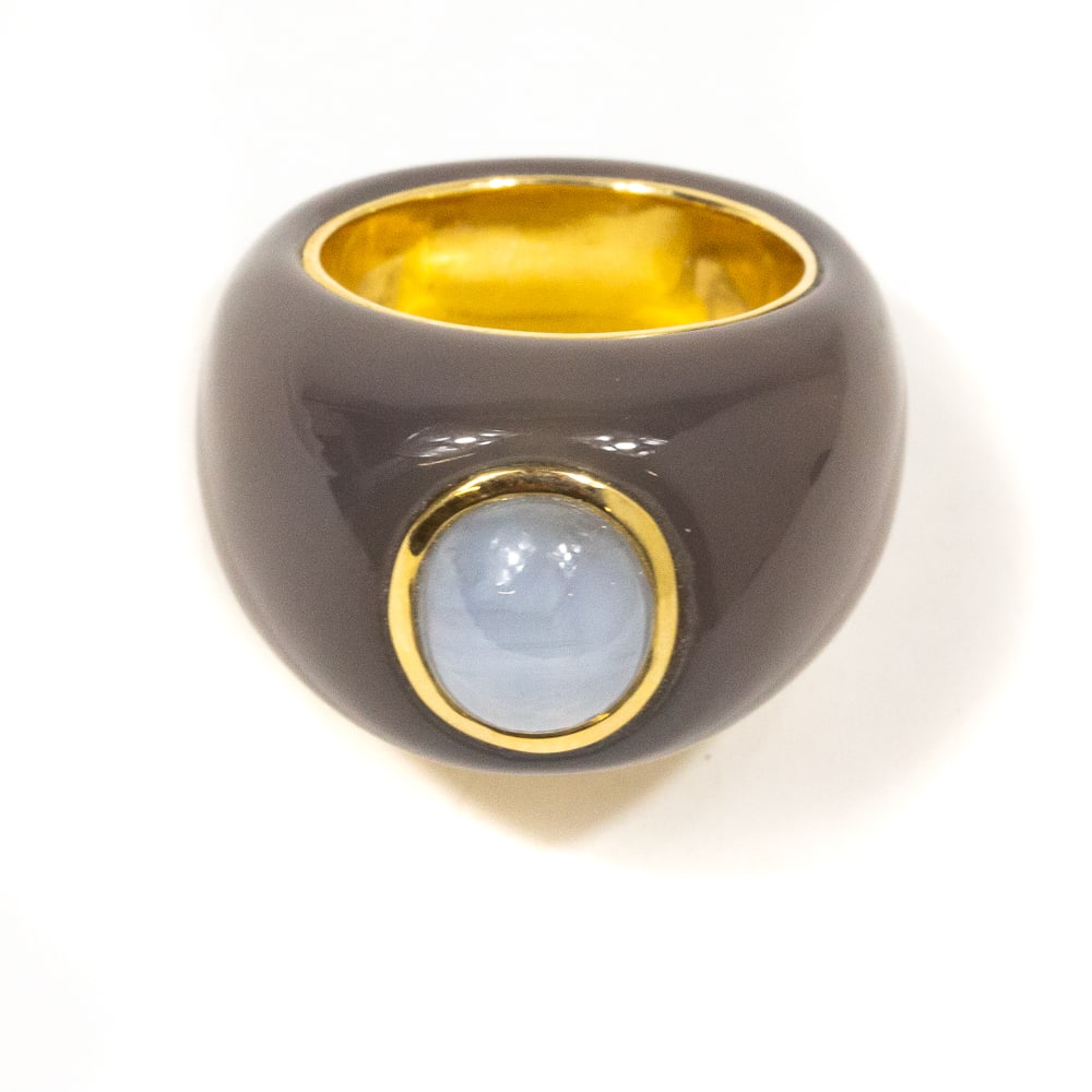 Carved Chalcedony, Star Sapphire & Gold Ring: Carved chalcedony, collet-set pale gray star sapphire and yellow gold ring, interior shank marked 14K. [10.45 dwt.; Ring size: 6.5]. Overall condition is good, well defined star. From the esteemed col