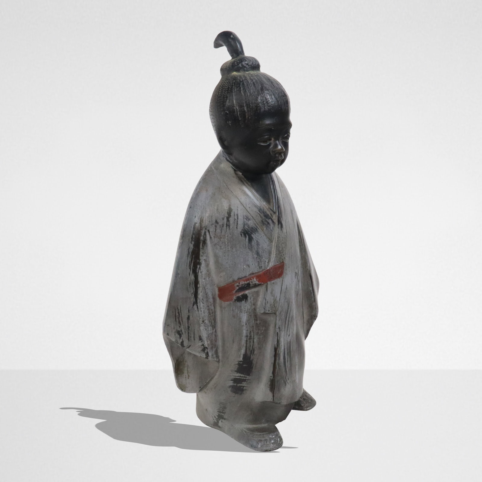 Japanese Lacquered Bronze Sculpture of a Boy: Japanese lacquered bronze figure of a boy, mid-20th century, with further cold painted details and a partial mark to base. [9" H x 4.5" W x 3.5" D]. Condition is good with light wear to finish.