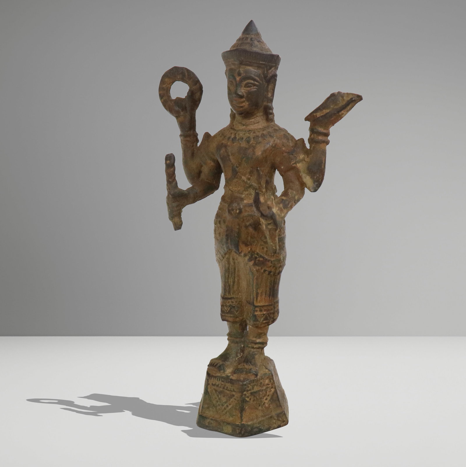Khmer Camodian Diety Statue: Khmer statue of a diety, Cambodia, 20th century, in white metal with a weighted interior. [10" H x 5" W x 3.5" D]. Condition is good with simulated wear.