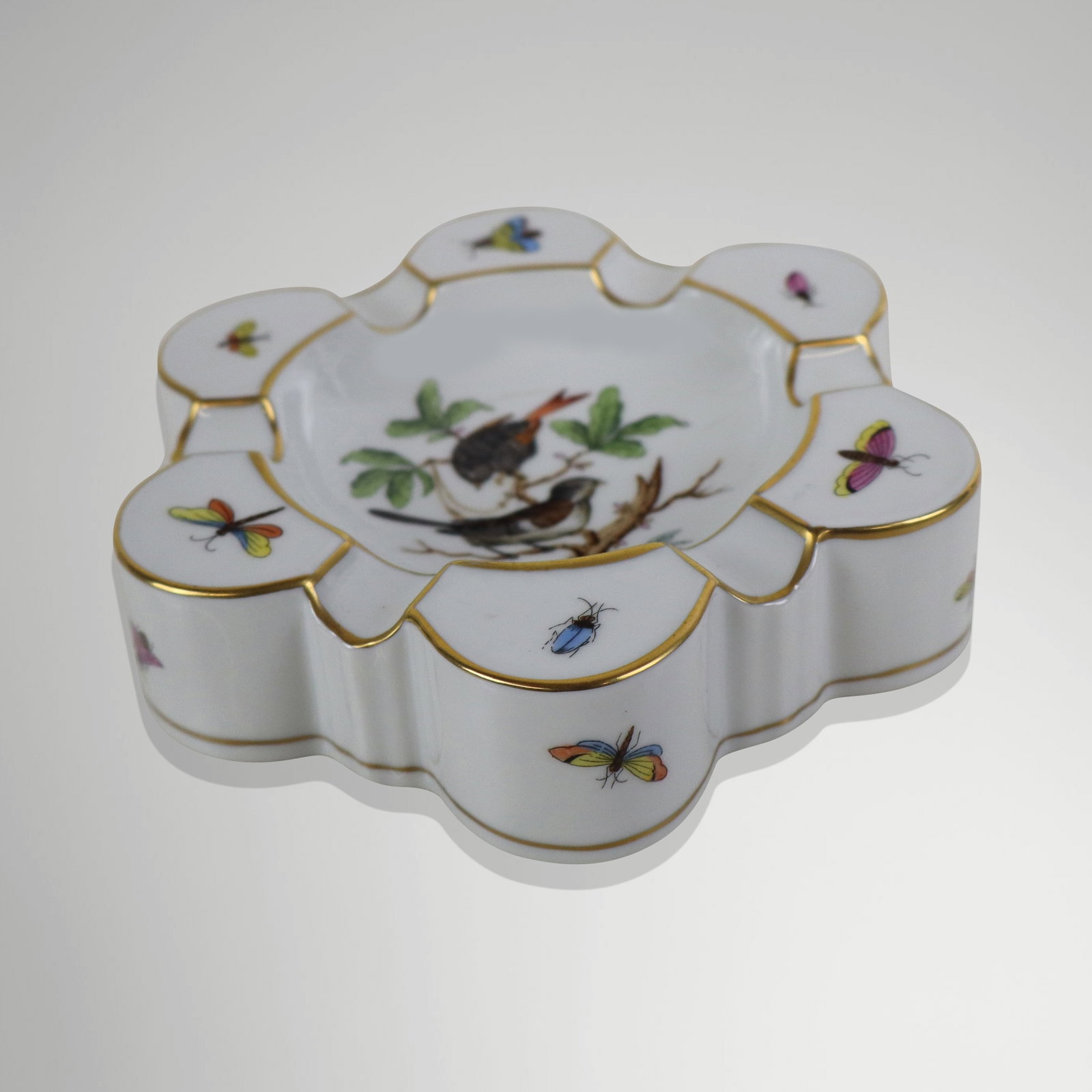 Herend Hand-Painted Porcelain Ashtray: Herend porcelain ashtray, Hungary, 20th century, with hand-painted bird and insect and gilt detail, marked Herend to base. [1.5" H x 6" Diameter]. Condition is good.