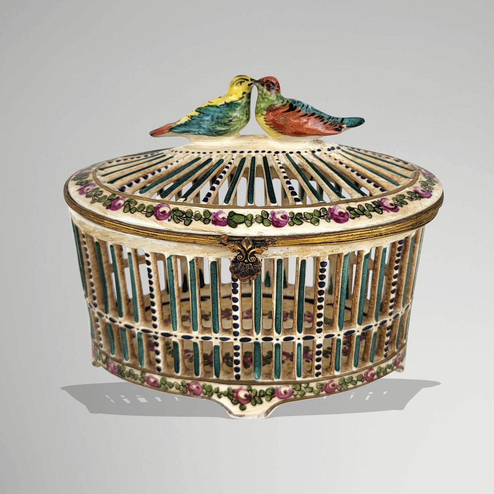 Porcelain Birdcage-Form Trinket Box: Porcelain box in the form of a birdcage, 19th century, with hand-painted floral details, and two bird finial and intricate pierced design, marked spuriously Sevres to base in two places at base. [4.5"
