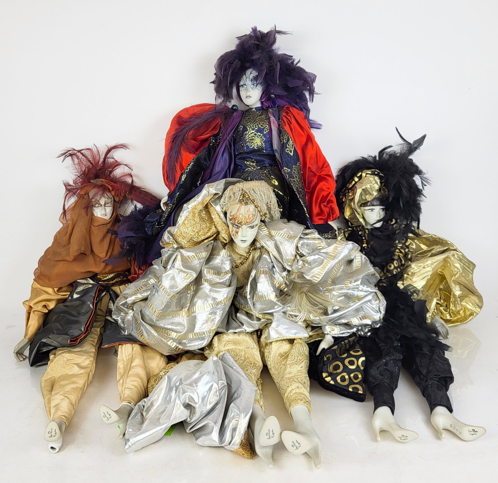 Marie Paule Rigodon Poupee Porcelain Dolls, 4: Four poupee porcelain fashion dolls by Marie Paule Rigodon atelier, France, circa 1980s, including a doll with feather and beadwork adornments, signed Sylvie, 1987 to temple, a doll in feather and Chi