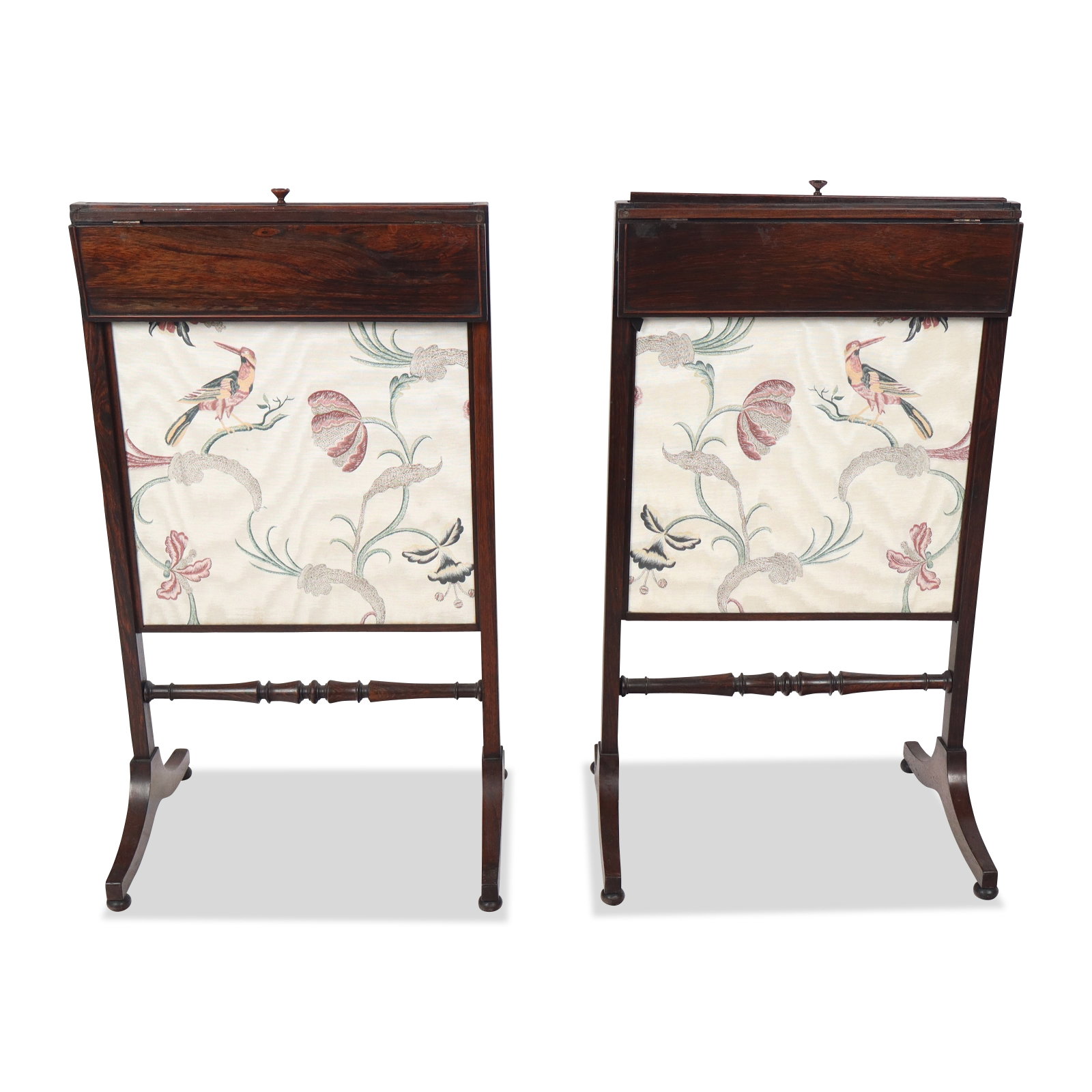 Pair of Rosewood Fire Screens: Pair of rosewood fire screens, with embroidered bird and floral decorated panels and with a drop down support. [34" H x 19" W x 15" D]. Condition is good with losses to finials and some wear to silk.