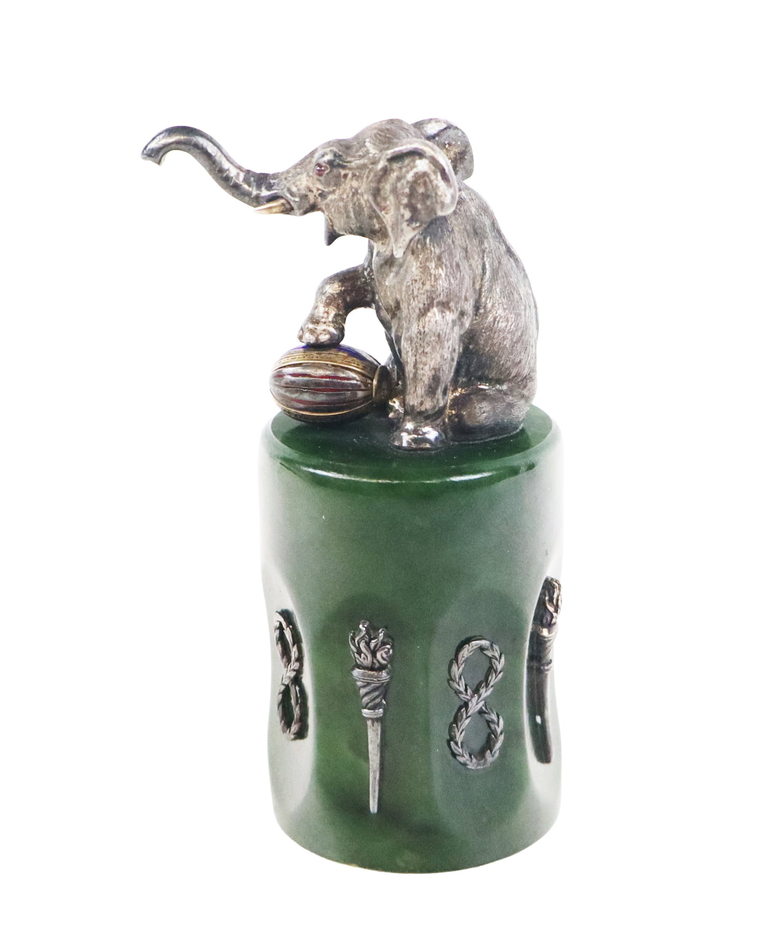 Faberge Manner Russian Silver & Nephrite Cup: Faberge-inspired silver and nephrite cup, 1908-1917, designed as a seated elephant with raised trunk and vermeil tusks, one foot resting on a blue and red enamel decorated ball, joined to the base of 