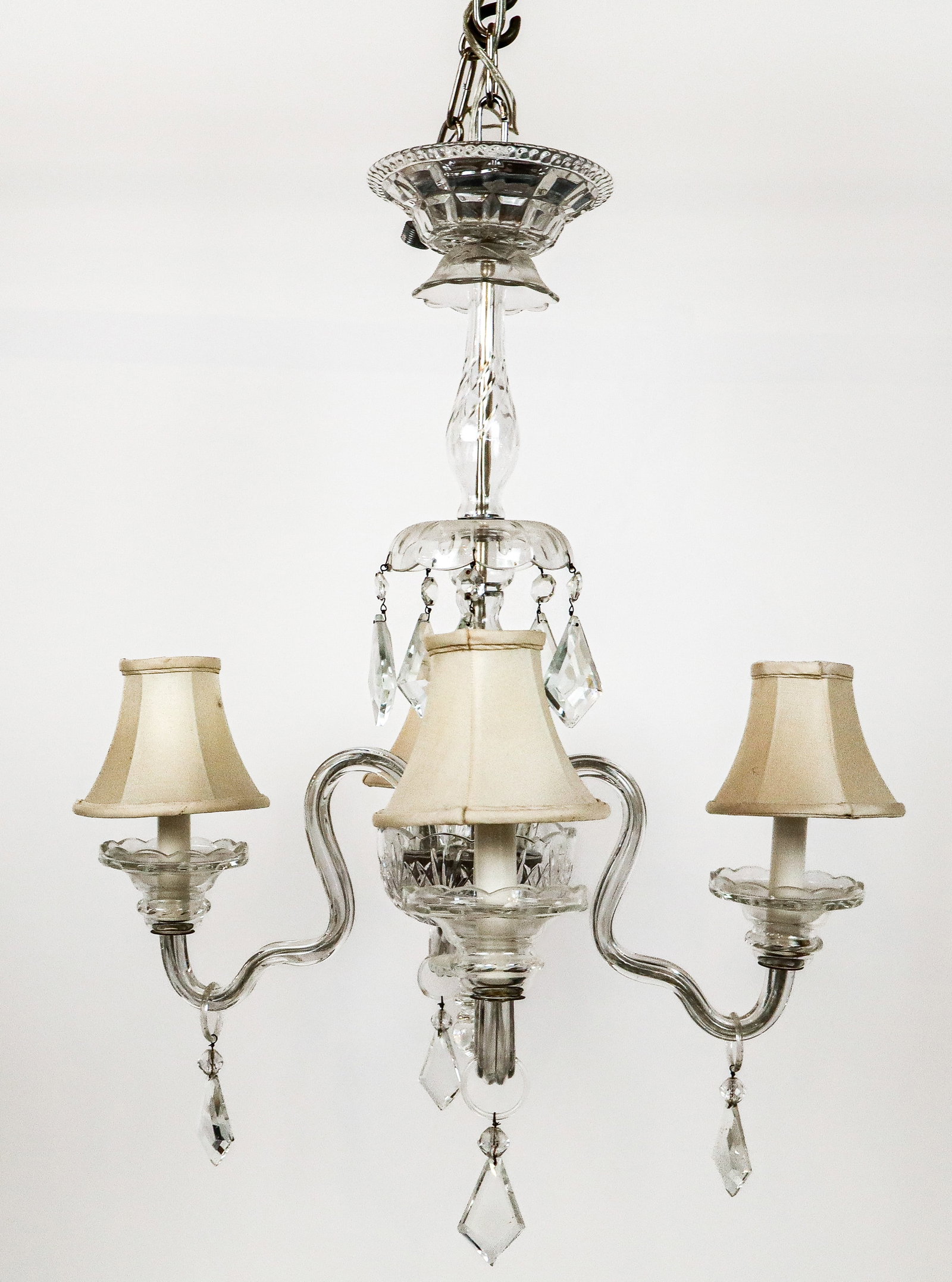 Crystal Four-Light Chandelier: Crystal four-light chandelier, 20th century, with etched details and faceted lustres and girandole arms. [26" H x 20" Diameter]. Condition is good with some minor fleabites, loss at lower stem, and a 