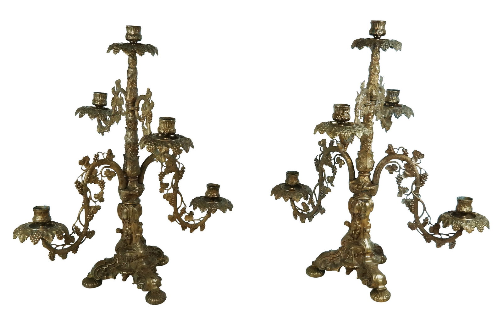 Pair of Victorian Ornate Brass Candelabra: Pair of Victorian gilt brass five-light candelabra heavily decorated with grapes and leaves, probably late 19th century. [21.5" H x 18" W x 14.5" D]. Overall condition varies, with some residue, top s