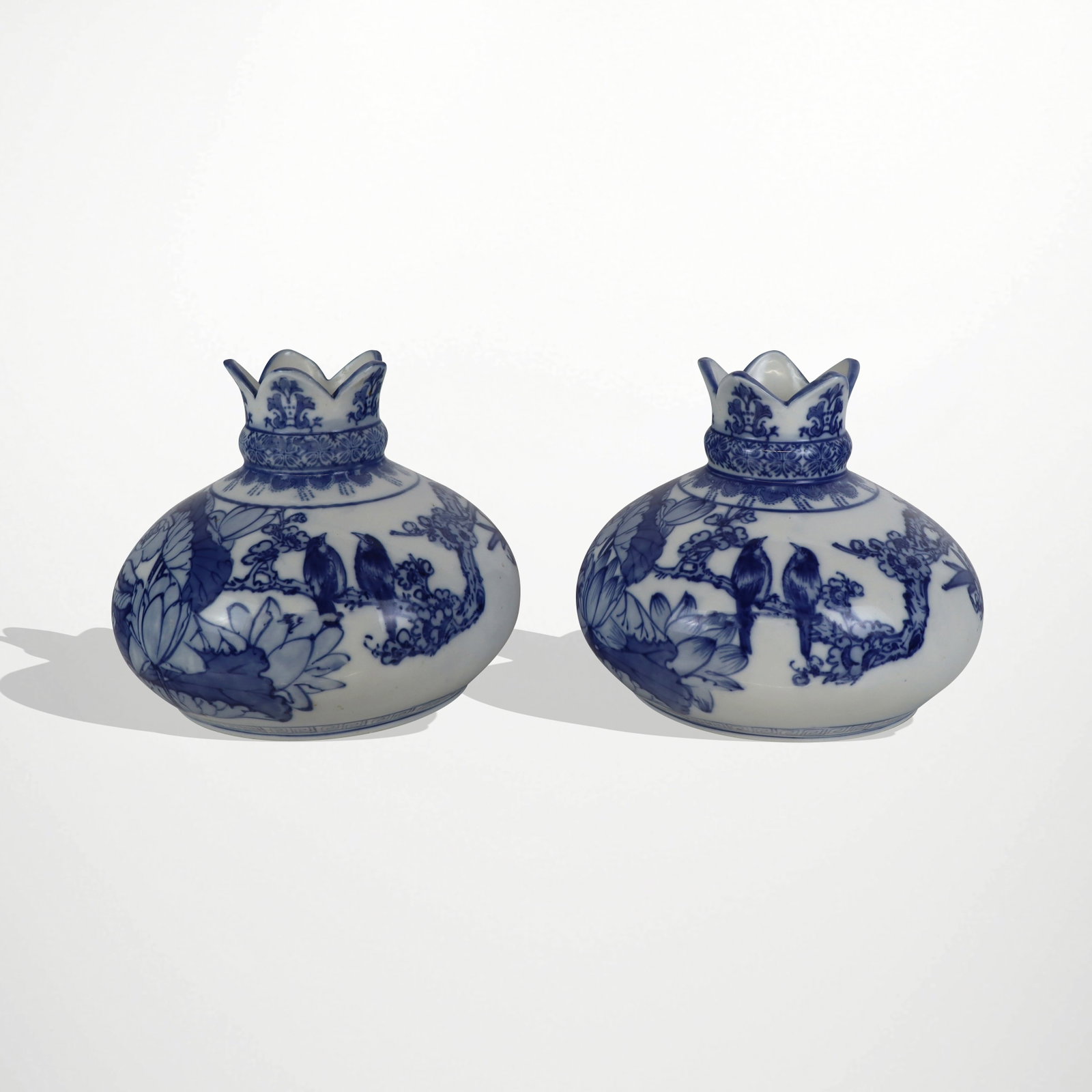 Chinese Pair of Qinghua Decorated Vases: Pair of Chinese Qinghua decorated vases, 20th century, with hand-applied floral design, and with an archaistic mark to base of each. [8.5" H x 10.5" Diameter]. Condition to each is good.