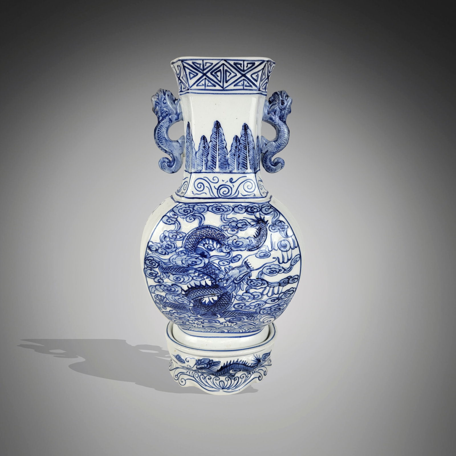 Chinese Blue and White Decorated Vase on Stand: Chinese blue and white decorated vase, 20th century, on a matched porcelain stand, with hand-painted decoration and decoration in relief, vase marked to base. [Including stand: 16.5" H x 9" W x 6" D].