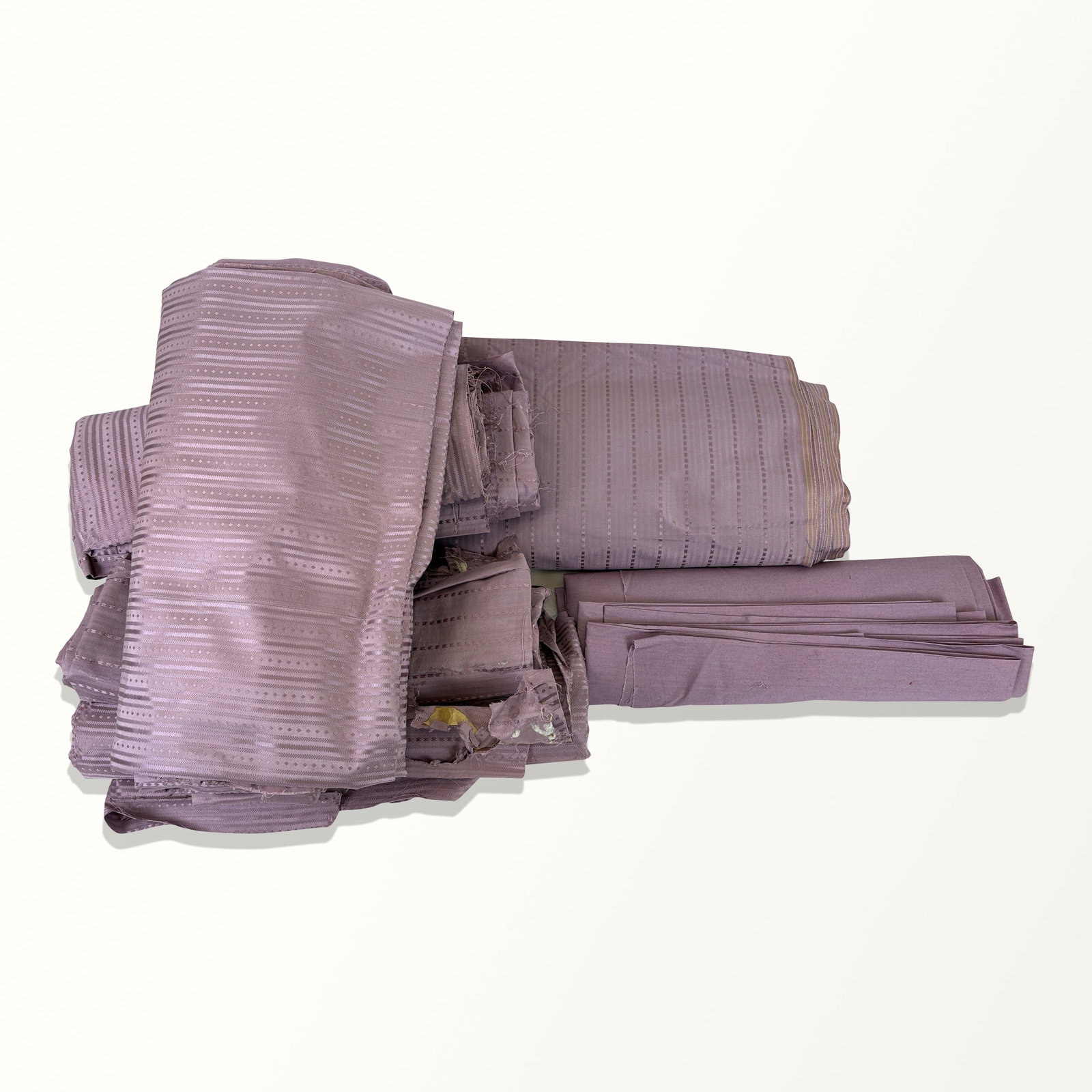 Bolts and Fragments of Lavender Striped Fabric: One bolt and 4 partials of striped 20th century American fabric, including one sheet of plain fabric. Bolt approx 6 yards. Some stains, some tattered ends. Property sold on behalf of the Brooklyn Muse