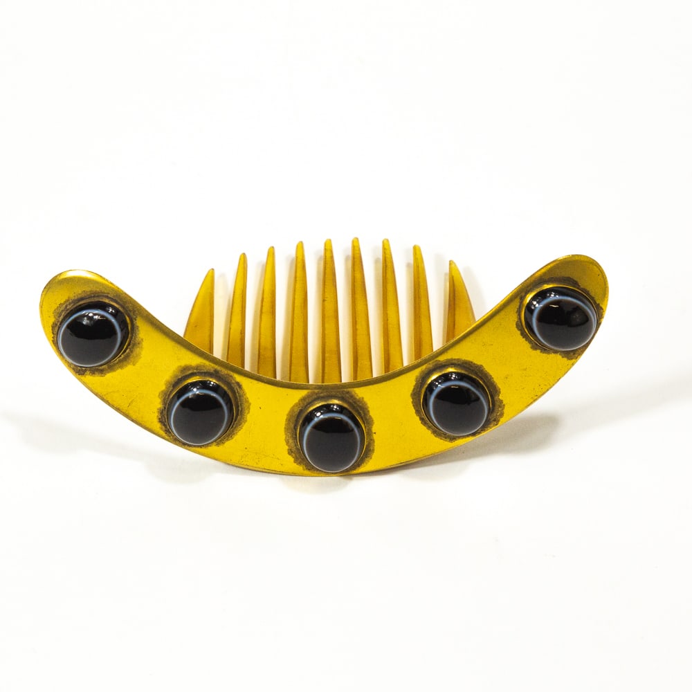 Victorian Brass & Bull's Eye Agate Hair Comb: Victorian brass and bull's eye agate hair comb, English, 1875, the hinged crest mounted with five bull's eye agate cabochons, with makers mark to reverse. [2.5" H x 4.25" W]. Overall condition is good