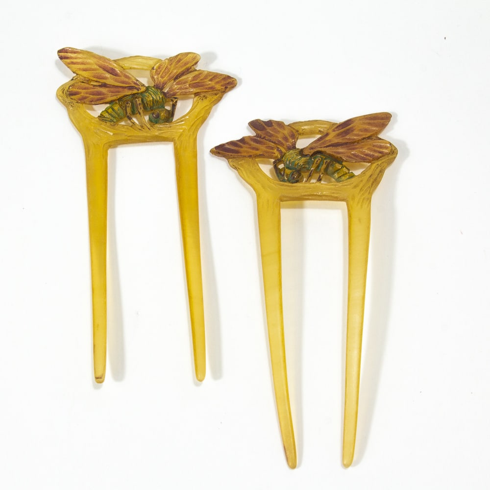 Pair of Art Nouveau Georges Pierre Carved Combs: Pair of Art Nouveau Georges Pierre carved horn painted hair combs, French, late 19th-early 20th century, each having two tines surmounted with dragonfly crests, one marked to reverse "GIP". [4" H x 2.