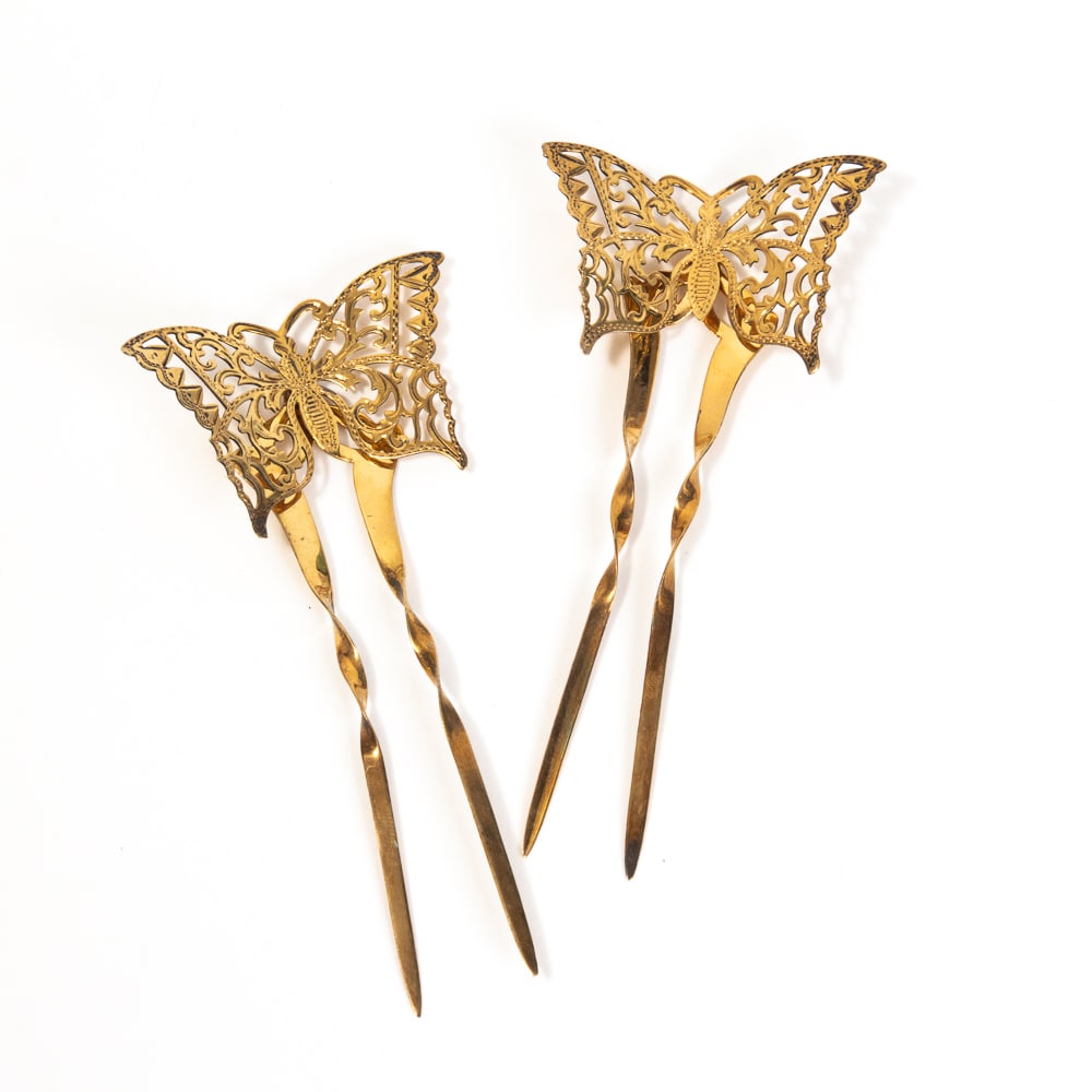 Pair of Edwardian Vermeil Butterfly Hairpins: Pair of Edwardian butterfly hinged hairpins, Birmingham, 1908, by Adie & Lovekin Ltd., the two tine twisted pins surmounted with reticulated butterflies, with hallmarks to reverse of pins. [Total weig