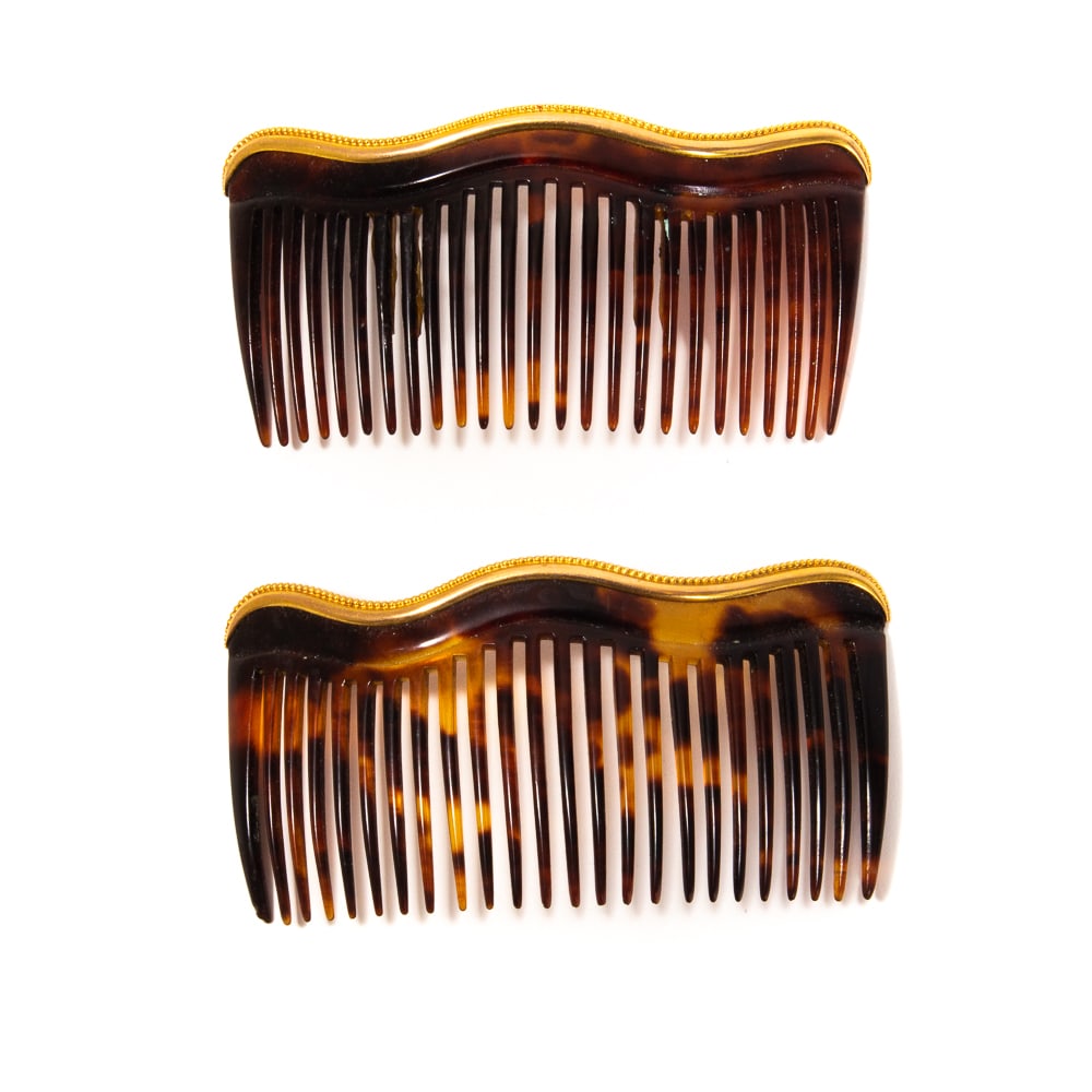 Pair of Victorian Gold Hair Combs: Pair of Victorian 14 karat gold hair combs, American, late 19th century, of simple beaded wavy design, each marked 14 with hallmark to reverse. [1.75" H x 3.5" W]. One broken and glued, otherwise fine