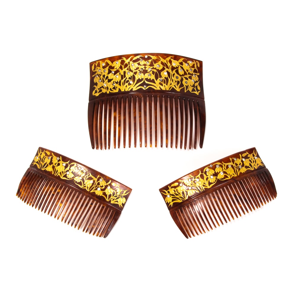 Set of Three Art Nouveau Gold & Paste Hair Combs: Set of three Art Nouveau gold and paste hair combs, American, late 19th-early 20th century, comprising a pair together with a larger comb, all decorated with a field of gold etched leaves with faux di