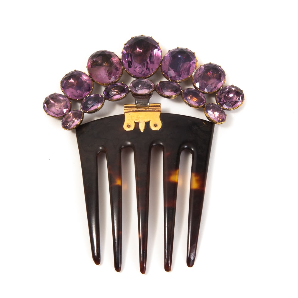 Antique Amethyst & Brass Hair Comb: Antique amethyst and brass hair comb, probably English, second half of 19th century, the hinged crest of crown shape set with graduated oval backed amethyst. [4" H x 3.25" W]. Overall condition is goo