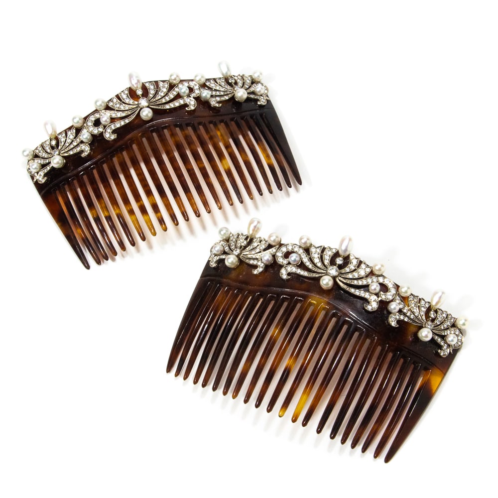 Pair of Belle Epoque Diamond & Pearl Hair Combs: Pair of Belle Epoque platinum topped yellow gold diamond and cultured pearl hair combs, probably 20th century, the shaped comb with stylized feather motifs, having 290 round brilliant cut diamonds wit