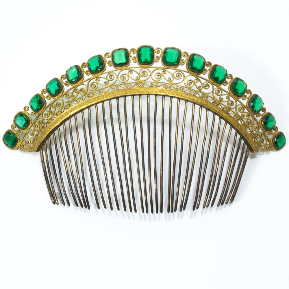 Early Victorian Gilt Metal & Green Stone Hair Comb: Early Victorian gilt metal and green stone hair comb, probably first quarter 19th century, the arched band defined by a line of oval cut green stones within scrolling pierced wire borders below a conf