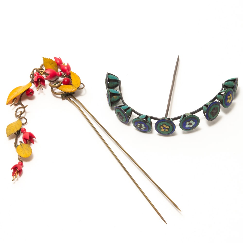 Two Japanese Enamel Floral Decorated Hairpins: Two Japanese enamel floral decorated hairpins, early-mid 20th century, including a two tine metal hairpin with a hanging tendril of red and yellow carved enamel foliage, and a single hair pick having 