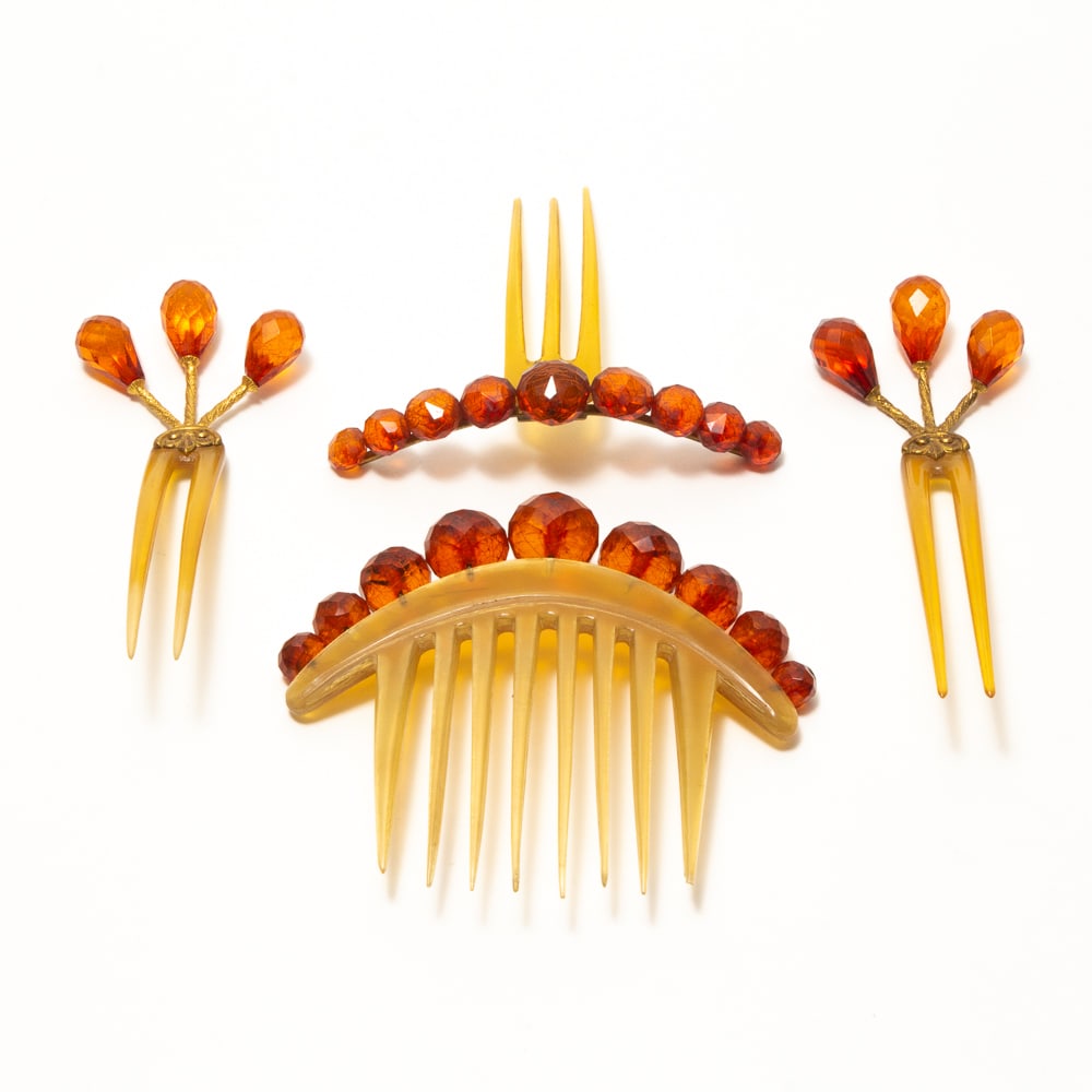 Group of 4 Victorian Horn & Amber Bead Hair Combs: Group of four Victorian carved horn and amber beaded hairpins / combs, late 19th century-early 20th century, including a pair of two tine pins having brass mounts with twisting vines terminating in th