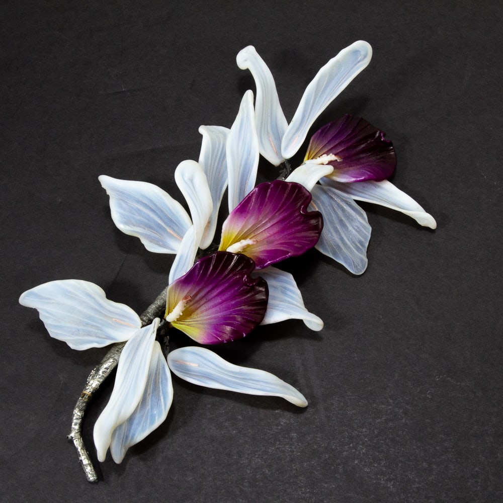 Glass Orchid Bouquet Corsage / Decorative Brooch: Glass orchid bouquet corsage / decorative brooch, 1930s-60s, the molded glass bouquet of deep magenta and yellow orchids surrounded by opaque white foliage and mounted to a wire-wrapped stem with pin.