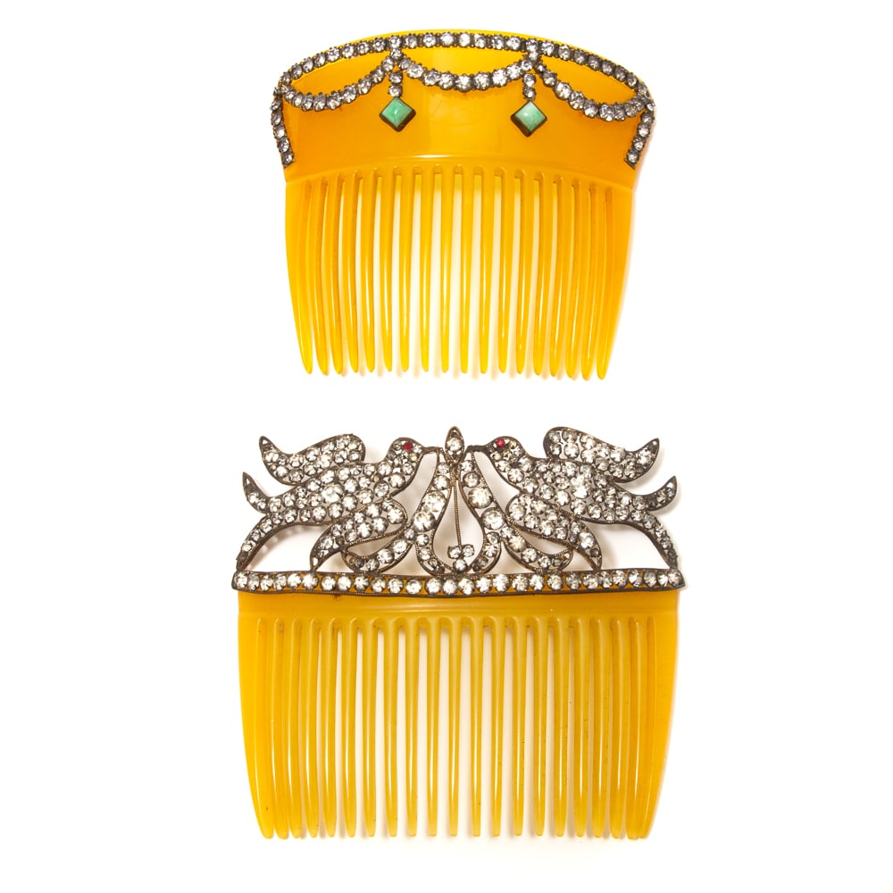 2 Art Nouveau French Paste & Celluloid Hair Combs: Two Art Nouveau French paste amber celluloid hair combs, 19th century-early 20th century, including one mounted with two love birds, the other with draped design and two turquoise colored cabochons. L