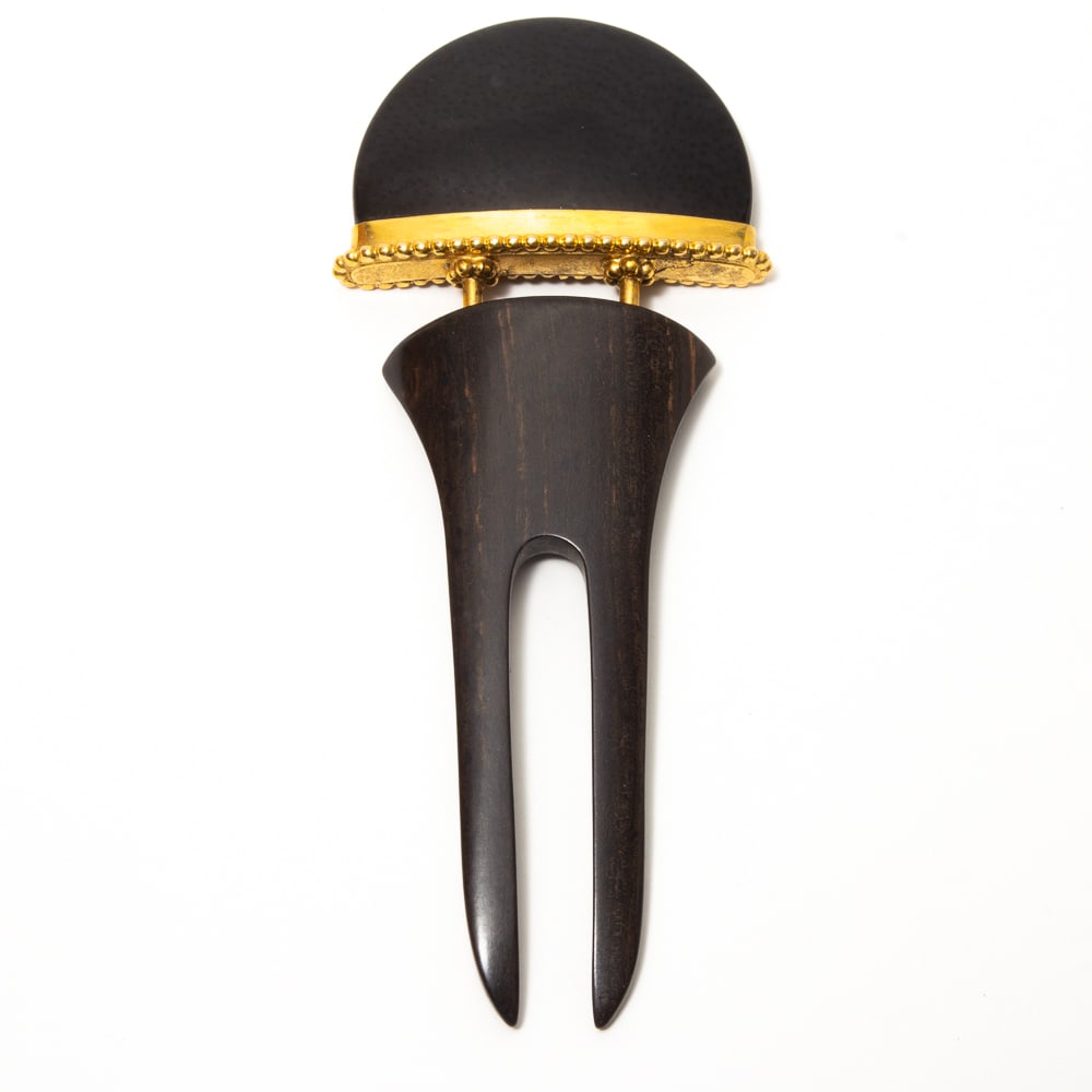 Hand Carved Wooden & Stone Mounted Hair Comb: Hand carved wooden and stone mounted hair comb, early-mid 20th century, the two tine dark wood comb mounted with a demilune semi-precious black stone set in a gold tone bezel with beaded border. [6.25