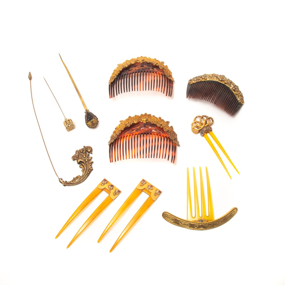 10 Antique Gilt Metal Ornamental Hair Combs: Group of 10 antique gilt metal ornamental hair combs, late 19th-mid 20th century, including a hinged brass hair comb with etched design, a pair of two tine picks with metal headers accented by three c
