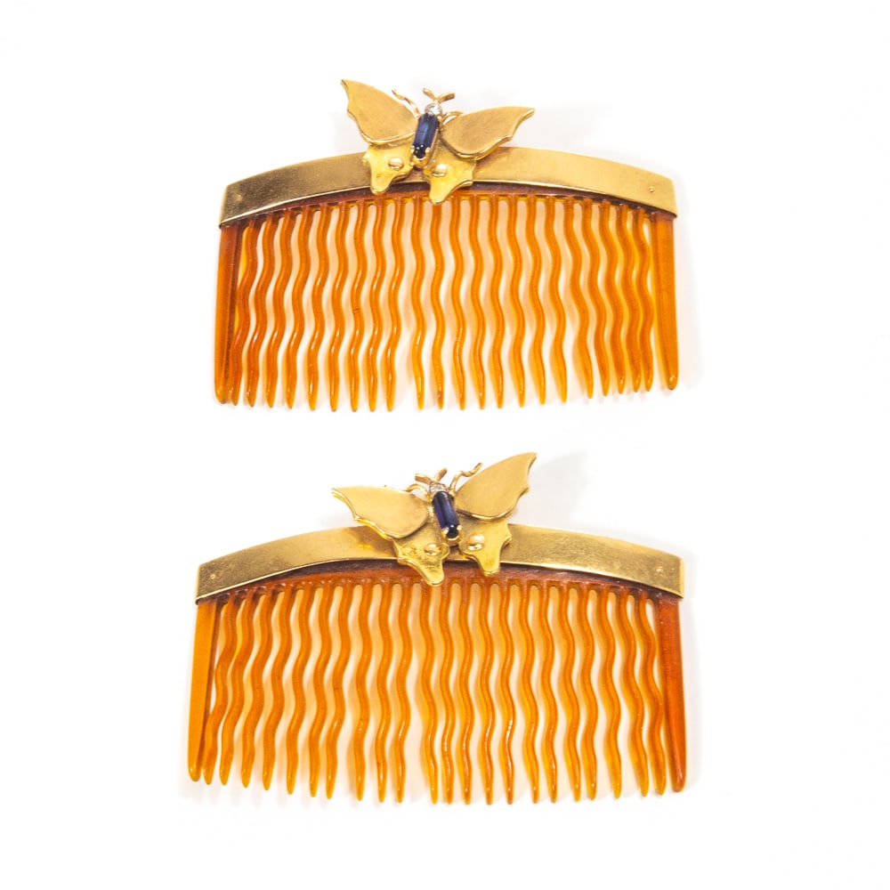 Pair of Rose Gold Butterfly Mounted Hair Combs: Pair of rose gold butterfly and stone mounted small hair combs, circa 1940, tests for 14K. [2" H x 2.75" W]. Overall condition is good with light surface wear and tine warping.