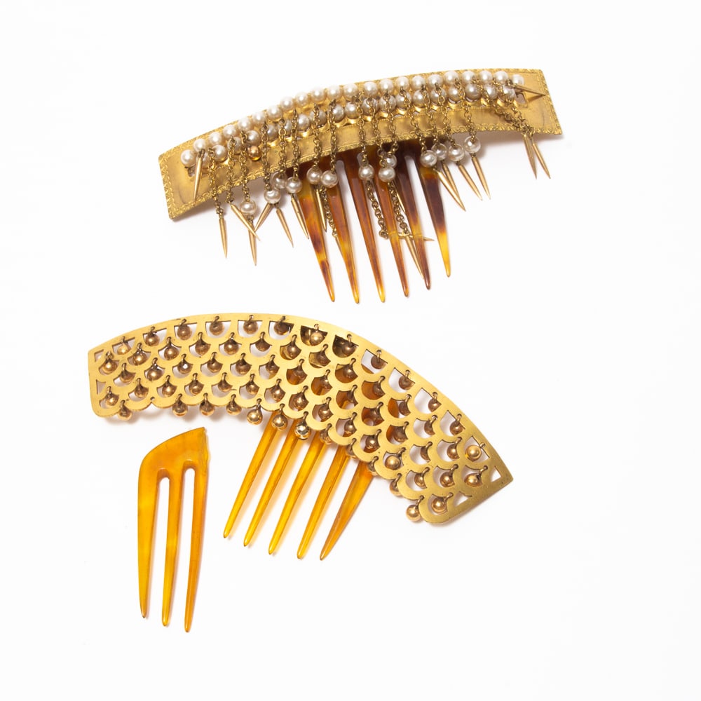 Two French Brass & Pearl Trembling Hair Combs: Two French brass and pearl trembling hair combs, late 19th-early 20th century, each on hinged mounts with elaborate crests. [Larger: 3" L x 5" W]. Overall condition is good with light wear.