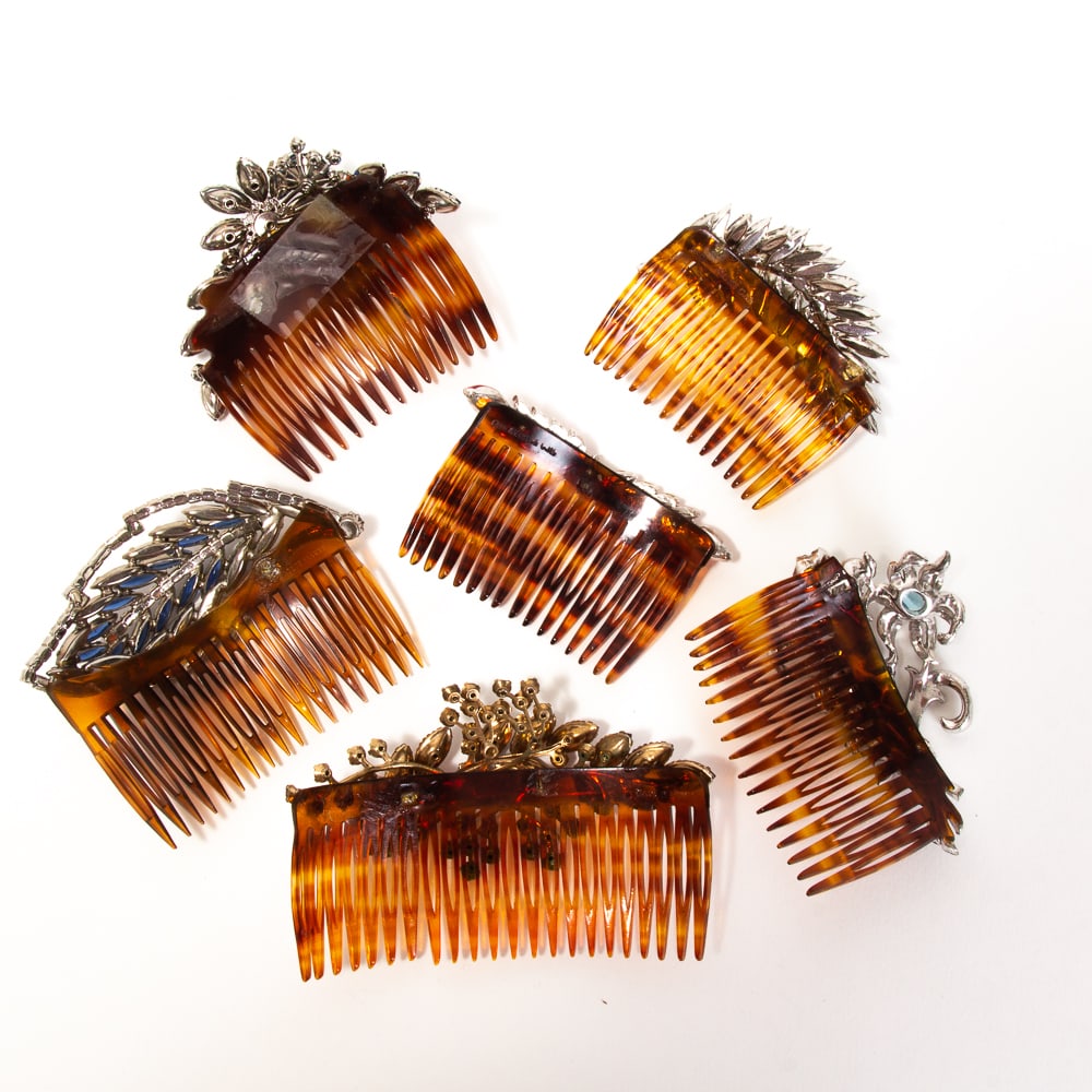 Group of 6 French Botanical Hair Combs: Group of six botanical hair combs, French, early-mid 20th century, comprising various floral and foliate motifs set with colorful paste stones, two marked "Made in France", two marked "Made in France 