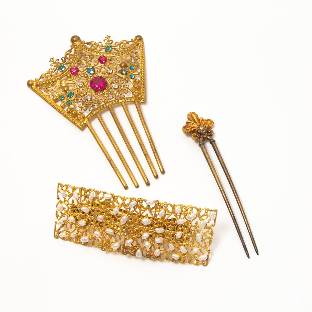 Group of 3 Brass & Gilt Metal Ornate Hair Combs: Group of three brass and gilt metal ornate hair combs, mid-late 20th century, including a large pierced brass crown comb with multicolor faux gem cabochons; a faux pearl barrette, marked to reverse "M