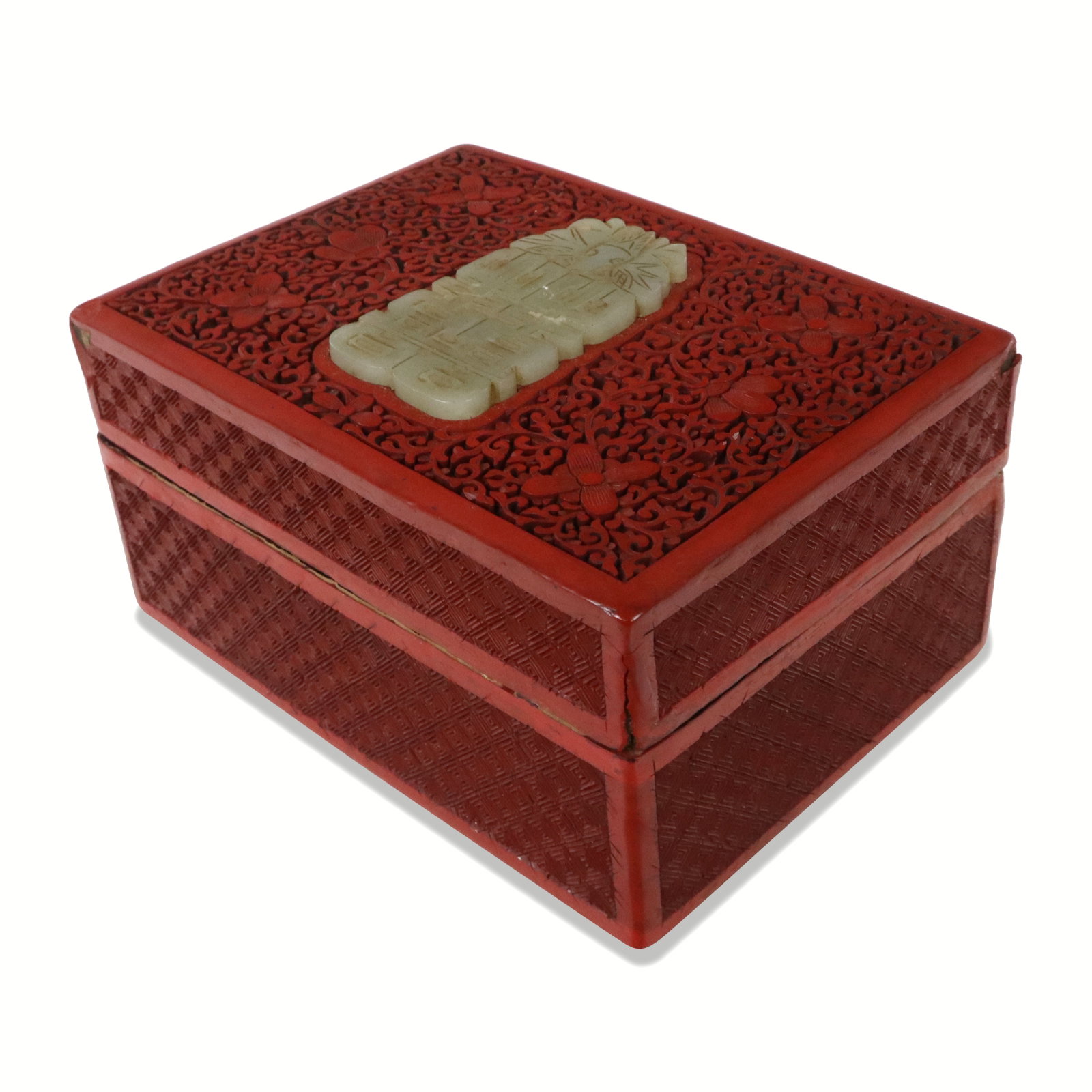 Chinese Cinnabar Box with Inset Jade: Chinese carved cinnabar box, 20th century, with carved jade double happiness medallion inset, and black lacquered interior. [3.75" H x 6.5" W x 5" D]. Condition is good with a loss to front right side