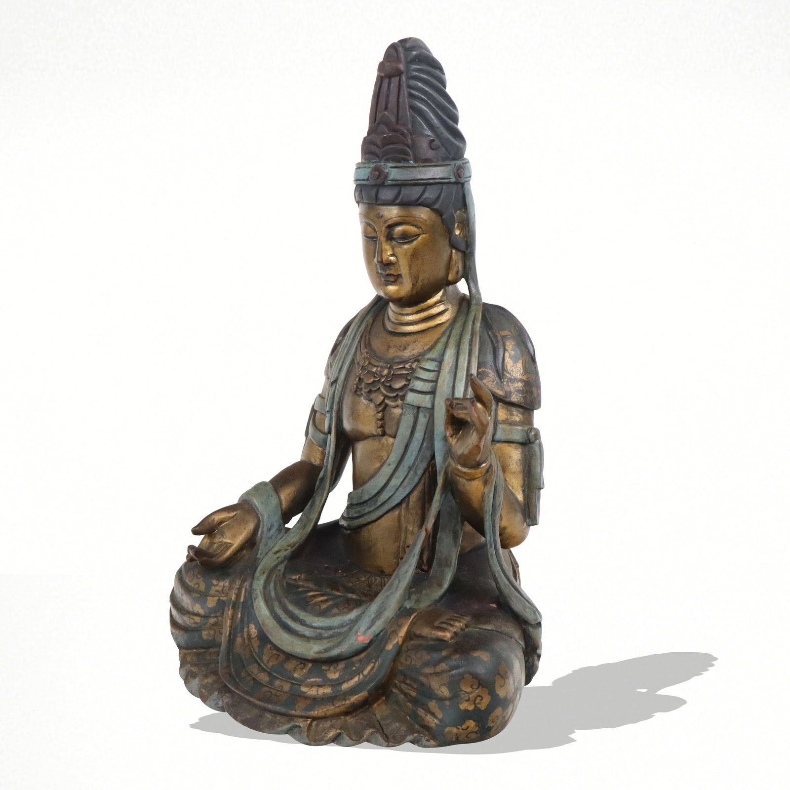 Carved and Painted Figure of Buddha: Carved and painted wood figure of Buddha, later 20th century, with gilt details. [17" H x 12" W x 11" D]. Condition is good with some surface wear and flaking to paint.