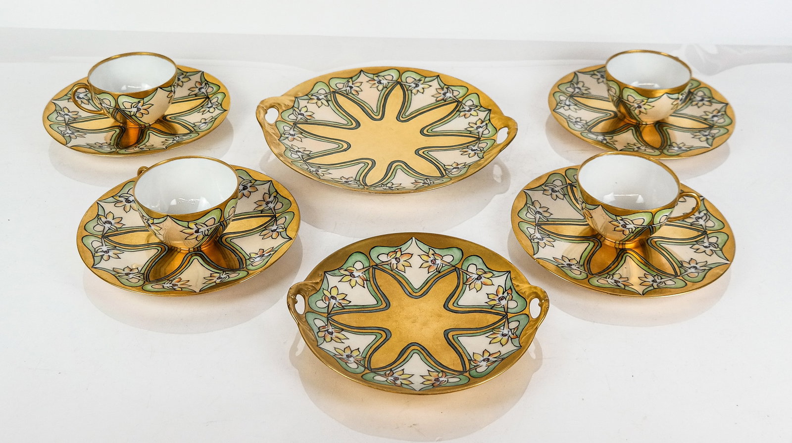 Tressemann & Vogt Porcelain Dessert Set, 10: Tressemann & Vogt arts and crafts inspired hand-painted gold and daffodil dessert set, Limoges, comprising two serving plates and four tea cups and saucers, marks to base, blanks Tressemann & Vogt or 