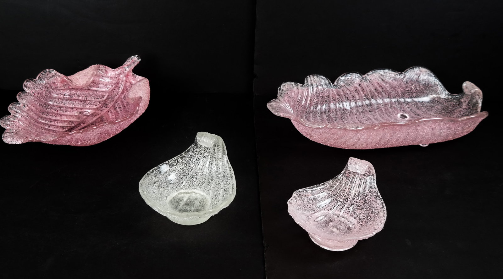 Collection of Overshot Art Glass Serving Pieces, 4: Collection of overshot glass serving pieces, probably Murano, possibly by Fratelli Toso, comprising a pink elongated leaf from bowl on ball feet [3.75" H x 16" L x 8" W], a pink leaf shaped bowl on co