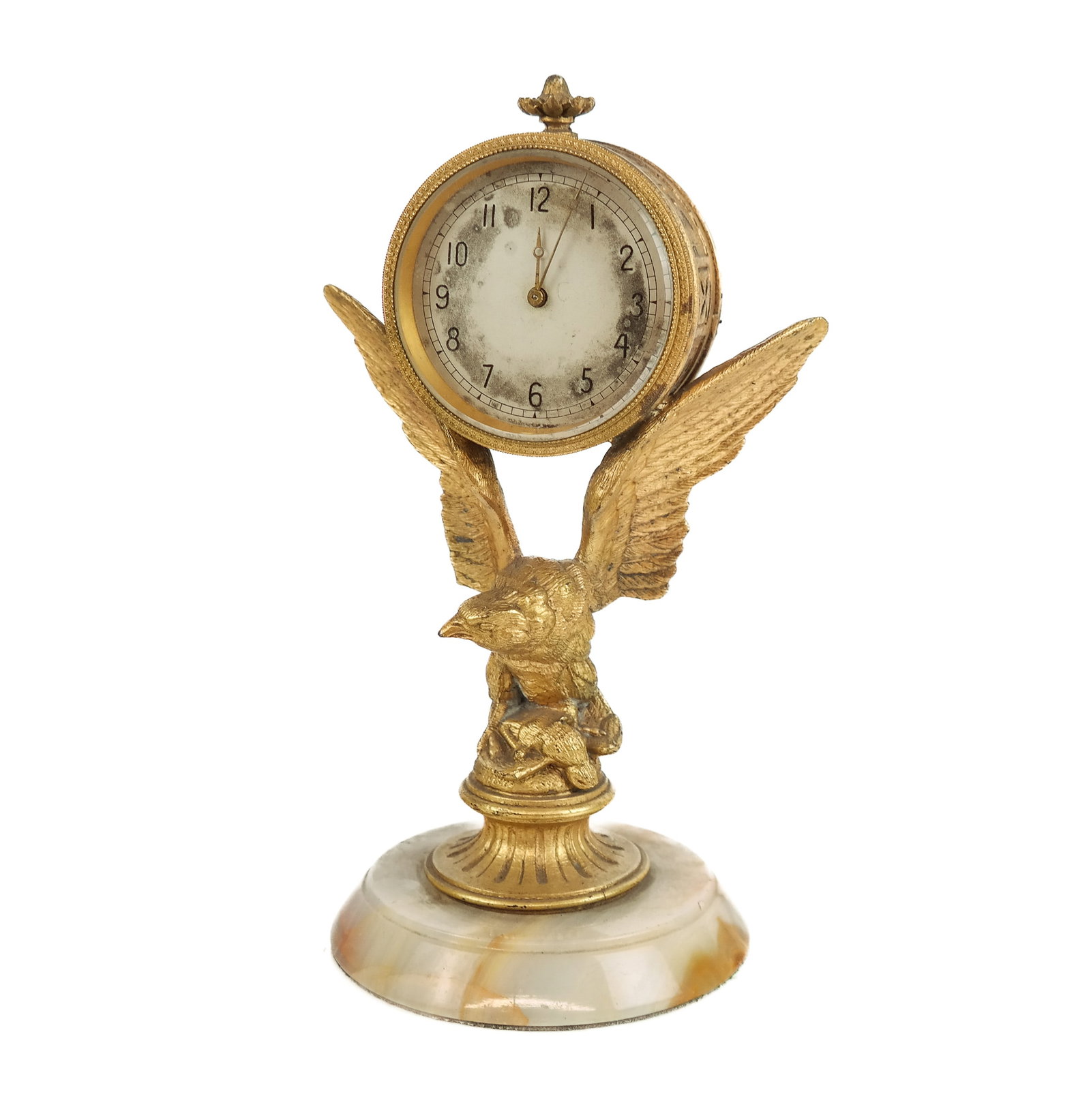 Gilt Bronze and Stone Eagle Form Desk Clock: Gilt bronze and stone eagle form desk clock, 20th century, featuring a round and gilt bronze encased clock face with geometric patterned sides resting on the wings of an eagle on top of prey, all stan